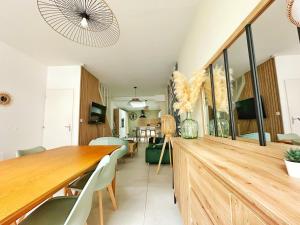 a dining room with a wooden table and chairs at L'Échappée Croisienne in Croix +68 photos