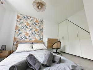 a bedroom with a large bed and a wall at L'Échappée Croisienne in Croix