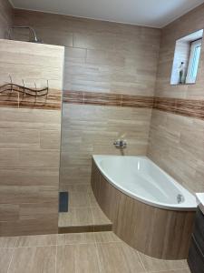 a large bathroom with a tub and a sink at Vadviraghaz in Palkonya +32 photos