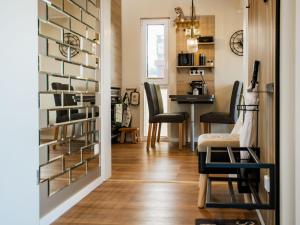 a room with a hallway with chairs and a table at Tiny Haus Schwalbe in Groß Kordshagen