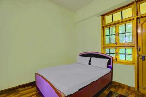 a small bed in a room with a window at Hotel O AP Hotel in Sitāpur +17 photos