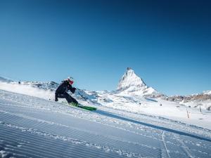 a person is skiing down a snow covered mountain at Center peak apartment Zermatt in Zermatt