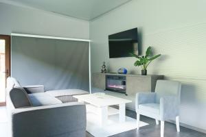 a living room with a couch and a table and a tv at Pablo's place in Rezine