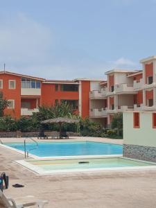 a swimming pool in front of a apartment building at MORADIAS I02/C in Prainha