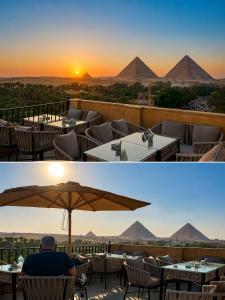 a man sitting under an umbrella in front of pyramids at New Gardenia Pyramids - Rooftop in Cairo