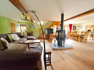 a living room with a couch and a wood stove at 5 Bed in Garth oc-c44957 in Garth