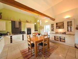 a large kitchen with a wooden table and chairs at 5 Bed in Garth oc-c44957 in Garth +16 photos