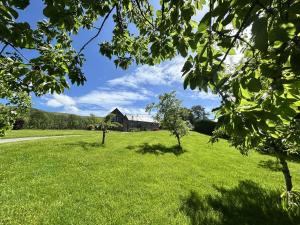 a field of green grass with a house in the background at 5 Bed in Garth oc-c44957 in Garth