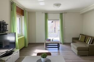 a living room with green curtains and a couch at La Terrazza di Gino in Grosio