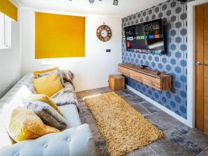 a living room with a couch and a tv at 4 Bed in Dothan Ty Croes oc-m44701 in Llanfaelog