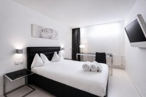 a hotel room with a bed with towels on it at VISIONAPARTMENTS Binzmühlestrasse 50 - self check-in in Zurich