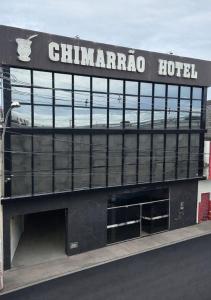 a chaminara hotel with a sign on top of it at Chimarrão Hotel in Juazeiro