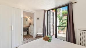 a bedroom with a bed and a large window at VILLA ALTHAEA 6, Emma Villas in Orbetello +39 photos