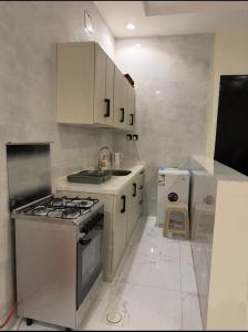 a kitchen with a stove and a sink in it at سويت لافندر in Abha +15 photos