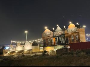 a large building with lights on it at night at سويت لافندر in Abha