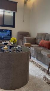 a living room with a couch and a coffee table at سويت لافندر in Abha