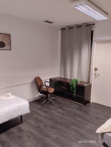 a bedroom with a chair and a desk and a window at Le Lilas - 6 in Cherbourg en Cotentin +9 photos