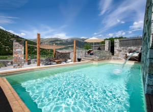 a pool at a resort with a mountain in the background at Traditional Villas Askyfou in Karés