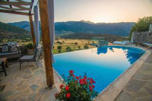 a swimming pool with a view of the mountains at Traditional Villas Askyfou in Karés
