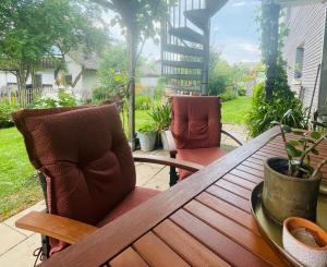 a wooden table and chairs on a patio at Glücksmomente in Wolfegg