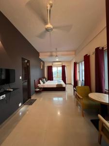 a bedroom with a bed and a tv in a room at Peace Residency in Jāmb