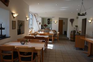 a restaurant with tables and chairs in a room at Feriengut Bohn in Bernkastel-Kues