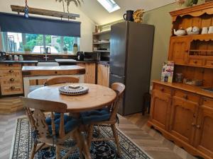 a kitchen with a wooden table and a refrigerator at 2 Bed in Partney oc-v44757 in Partney