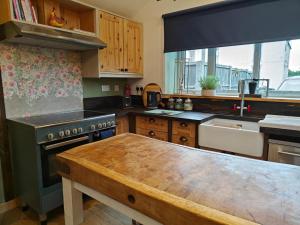 a kitchen with a wooden table in the middle of it at 2 Bed in Partney oc-v44757 in Partney +8 photos
