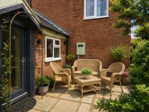 a patio with chairs and a table and a building at 2 Bed in Partney oc-v44757 in Partney