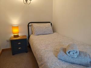 a small bedroom with a bed and a lamp on a night stand at 2 Bed in Partney oc-v44757 in Partney