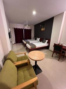 a living room with a couch and a bed and a table at Peace Residency in Jāmb