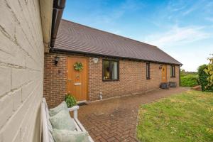 a brick house with a bench in front of it at 2 Bed in Buxted oc-t44744 in Buxted