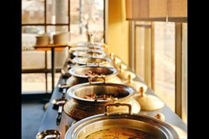 a row of pots and pans lined up on a table at FabHotel Aqua Pearl Inn in Navi Mumbai