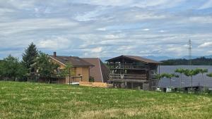 a house sitting on top of a grass field at Mutzgraben Lodge in Seeberg