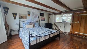 a bedroom with a bed with a blue comforter at Mutzgraben Lodge in Seeberg
