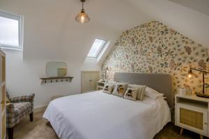 a bedroom with a white bed with a floral wall at 2 Bed in Docking oc-t44851 in Docking