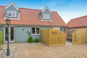 a house with a wooden fence in front of it at 2 Bed in Docking oc-t44851 in Docking