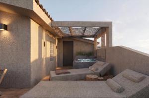 a rooftop patio with a couch and a table at D&C Premium Suites in Pefkochori