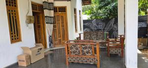 a group of chairs sitting outside of a house at Queens luma villa in Arugam Bay