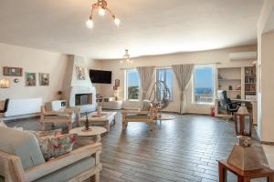 a living room with a couch and a fireplace at Villa Fotis in Ano Syros