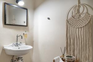 a bathroom with a sink and a mirror at Villa Fotis in Ano Syros +16 photos
