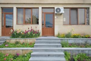 a house with a door and flowers in front of it at Soma Apart-hotel in Center in Yerevan
