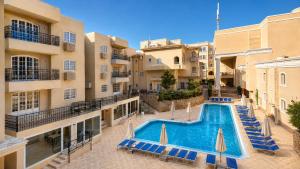 an image of an apartment complex with a swimming pool at Elysees Dream Beach Hotel-By AMARINA Hotels & Resorts in Hurghada