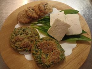 a plate of food with cheese and meat and vegetables at B&b CASCINA CORNELLA in Cremeno