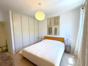 a bedroom with a bed and a pendant light at Cristoforis Lake View House in Carate Urio +20 photos