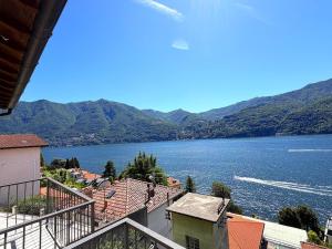 a view of a large body of water with mountains at Cristoforis Lake View House in Carate Urio
