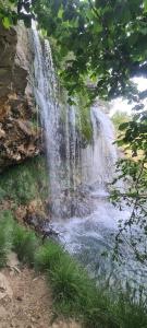 a waterfall on the side of a river at Casa Papi in Zafrilla