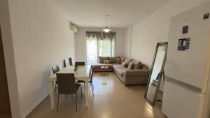 a living room with a couch and a table at Viluni Coast Apartment in Velipojë