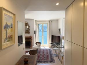 a living room with a dining room and a living room with a table at Cristoforis Lake View House in Carate Urio