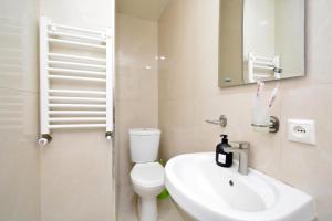 a bathroom with a toilet and a sink and a mirror at Soma Apart-hotel in Center in Yerevan +43 photos